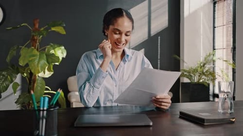 Successful Woman Reads Document in Modern Office