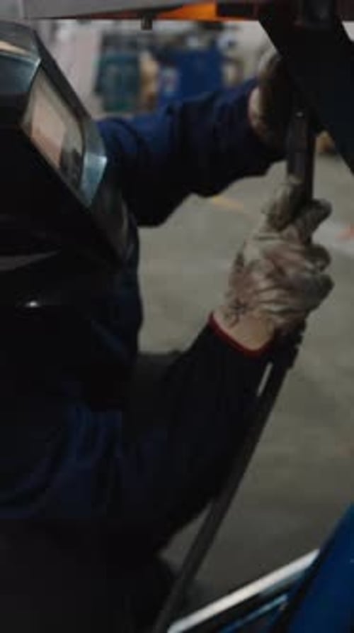 Professional Welder Fabricating Metal Structure in Workshop