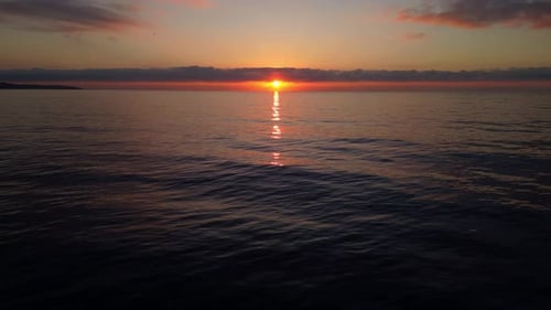 A Tranquil Drone Shot of a Stunning Sunrise Over Calm Ocean Waters with a Peaceful Horizon and