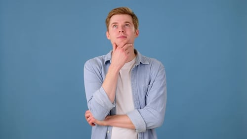 Man Ponders, Rejects Idea on Blue Background