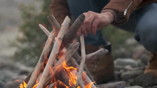 Hiker Tourist Traveler Man with Backpack Mountain Camping Fire Firewood Camp Tent Traveling Hiking