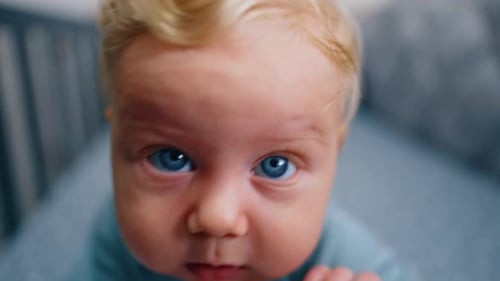 Adorable Baby Reaching in Crib, Close Up