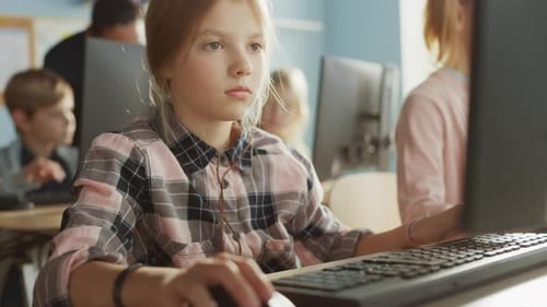 Elementary School Computer Science Classroom: Portrait of a Smart Cute Girl Uses Personal Computer,