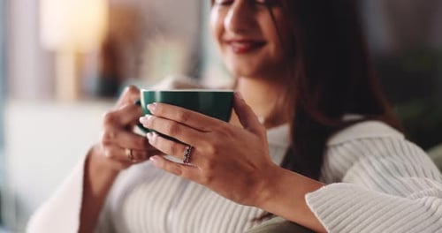 Hands, coffee and steam with aroma on couch in home, smile and relax with warm beverage in lounge