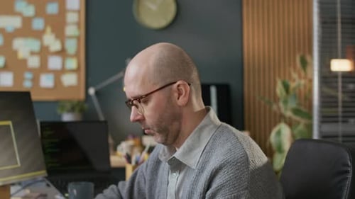 Portrait of Middle-Aged Male Programmer Working in Modern Office