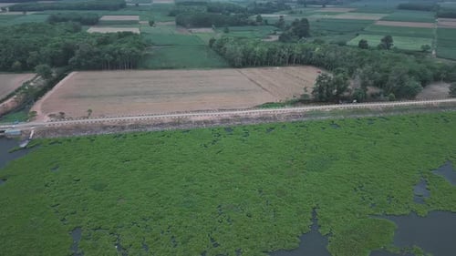 Aerial View Of A Landscape With Fields Forest Water And A Road