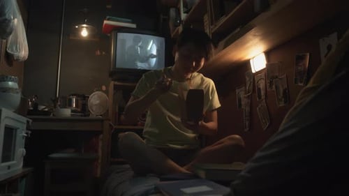 Chinese Woman Eating Takeaway Noodles in Shabby Capsule Apartment