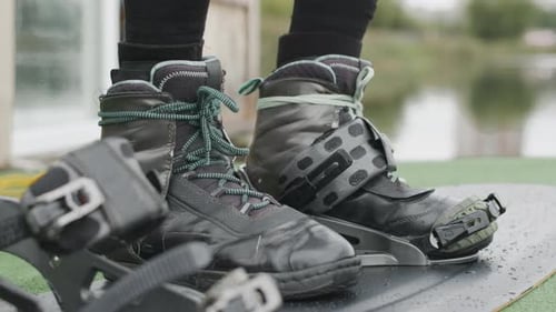 Man Preparing for Wakeboarding on Lake Dock