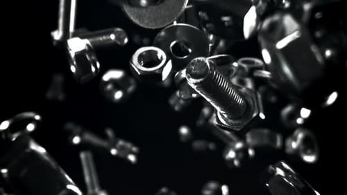Shiny Silver Nuts and Bolts Floating on Black