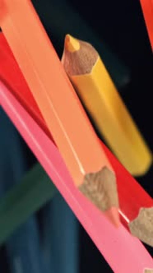 Multicolored Pencils Fly and Fall on a Black Background Filmed on a Highspeed Camera at 1000 Fps