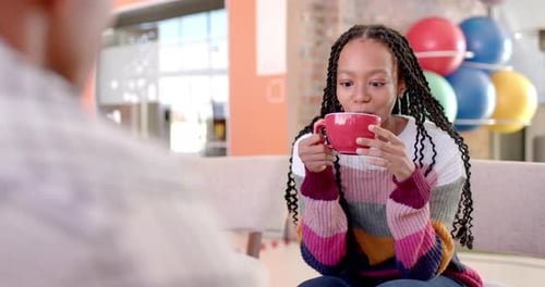 Diverse male and female colleagues in discussion in casual office meeting, slow motion