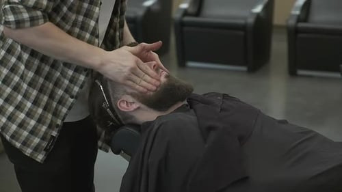 Barber Gives a Face Massage in a Salon