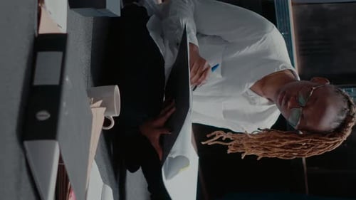 Businesswoman Reviewing Documents in Bright Office