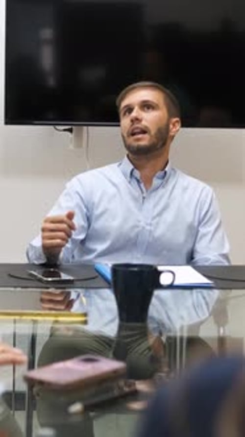 Man Speaking at a Table in an Office