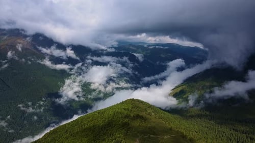 Alpine Valley Drone Captures Green Mountains and Misty Valley