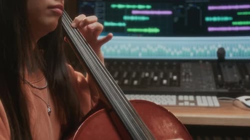 Cellist Playing Music in Recording Studio
