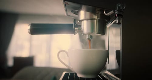 Pouring Coffee Stream From Machine in Cup Home Making Hot Espresso Using Filter Holder Flowing Fresh