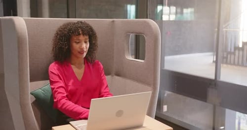 Stretching and relaxing, woman taking break from work with laptop in office