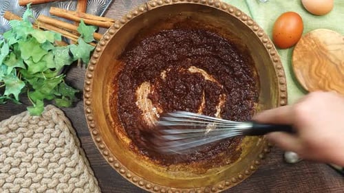 Mixing Dark Ingredients with Whisk in Bowl