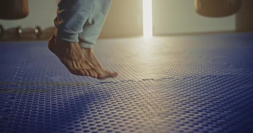 Active Man Jumping Skipping Rope in Sport Club