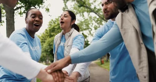 Excited Volunteers Stacking Hands in Urban Park