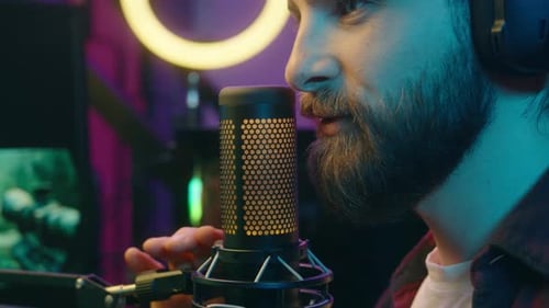 Man Talking Into Microphone with Headphones On