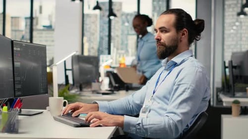 Man Working at Computer in Modern Office Environment