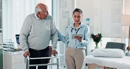 Senior Man Using Walker With Healthcare Professional