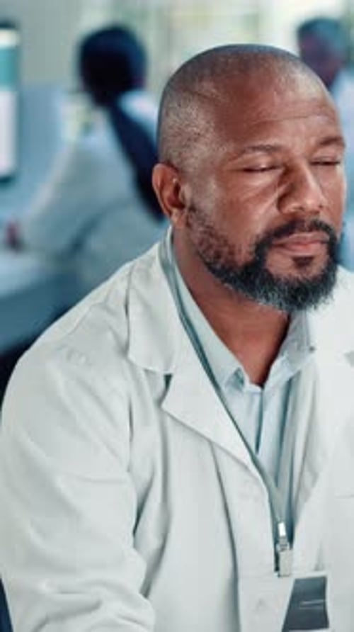 Doctor Contemplating Medical Breakthrough in Lab