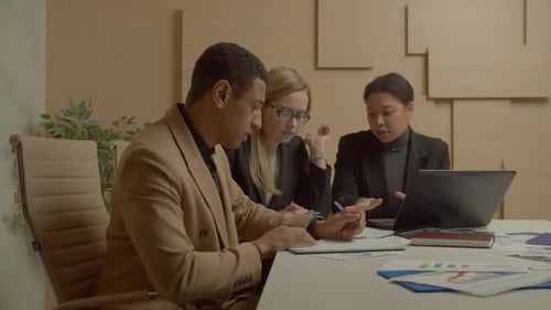 Young Professionals Collaborating on Business Strategy in Office