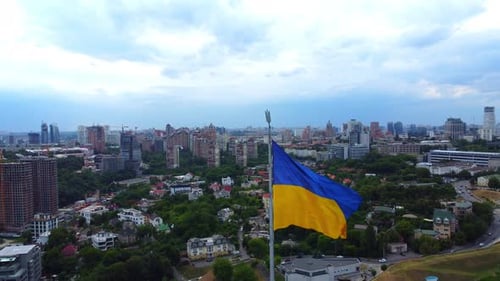 Ukrainian Flag Overlooking a Bustling Cityscape