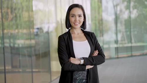 Confident Woman Poses with Arms Crossed in City