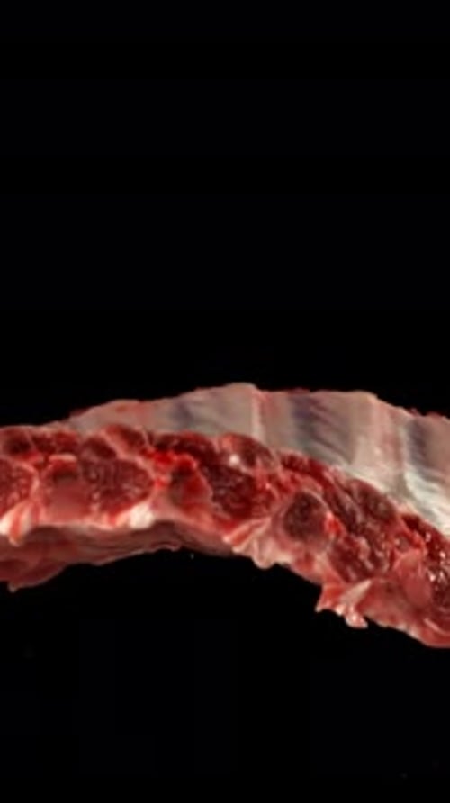 Raw Ribs Rise and Fall on a Black Background Filmed on a Highspeed Camera at 1000 Fps