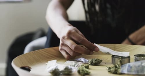Hands Working on Table with Grinder and Paper