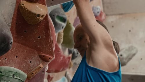Person Climbing Indoor Rock Wall