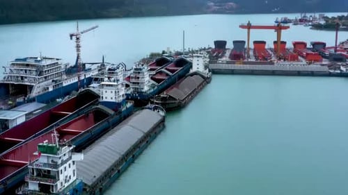 Industrial factory real shot of Shipbuilding and ship repair yard. Shipyard contains many cranes, dr
