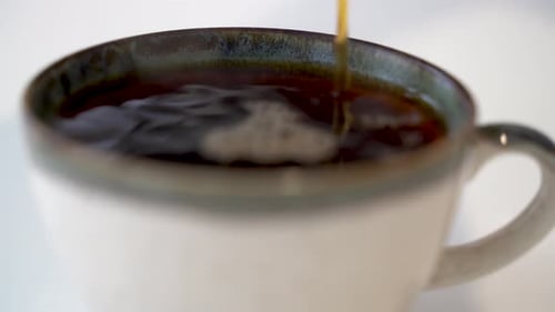 Close up pouring hot filter coffee into cup 4K