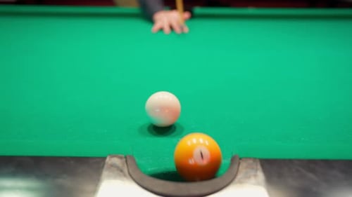 Billiard Ball Sinking into Corner Pocket on Pool Table
