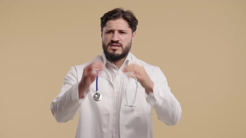 Bearded Doctor Expressing Frustration and Stress in Studio