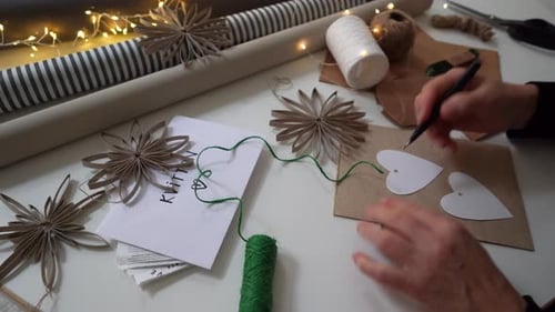 Adult Crafting Christmas Cards and Ornaments