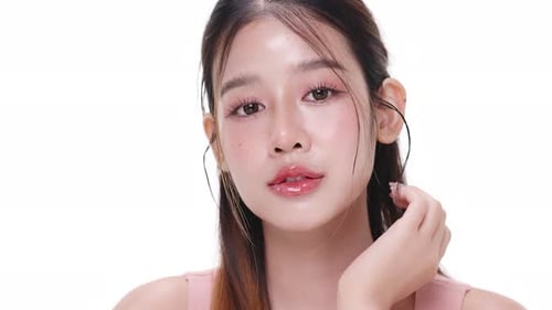 Close up portrait beautiful young Asian woman with healthy facial skin over white background.