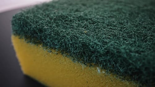 Macro Shot of a Cleaning Sponge with Green Scrubber