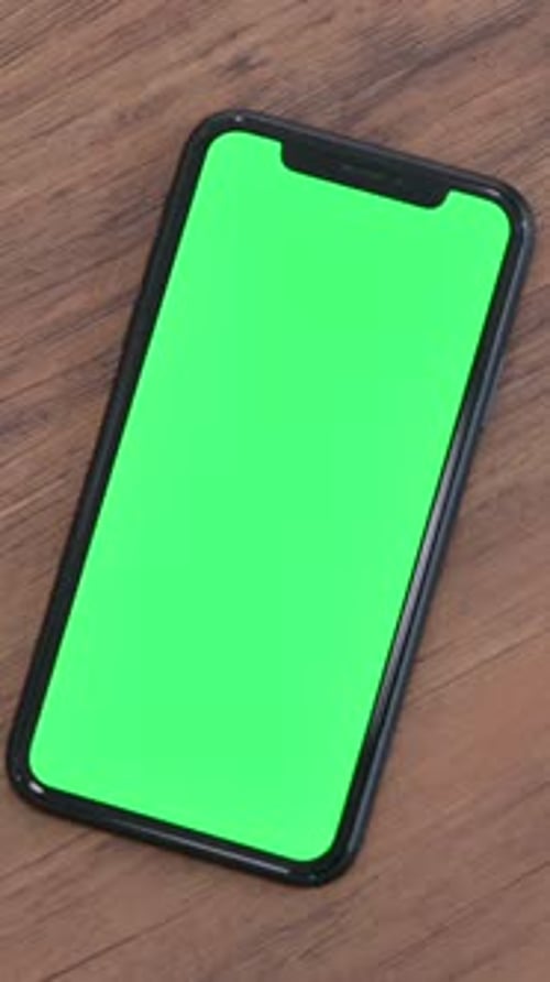 Hand using Smartphone on Table, Green Chroma Screen , Vertical Video
