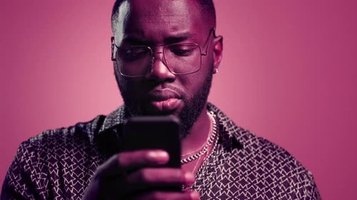 Man using smartphone showing shocked reaction close up