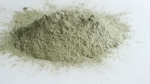 Close Up Green Clay Powder Rotates on White Background