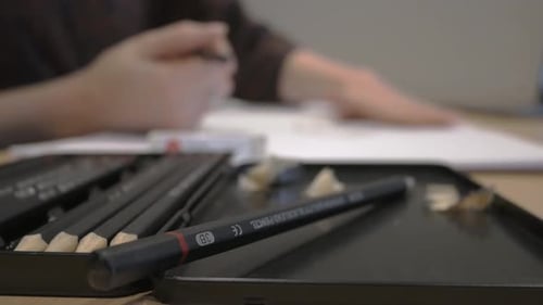 Young woman designing, sketching, drawing on a pad of paper 2