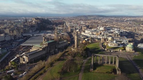 Aerial view from the top of Calton Hill in Edinburgh looking towards the city centre. Flying left to