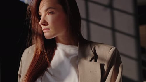 Young Woman in Jacket Posing in Sunlight