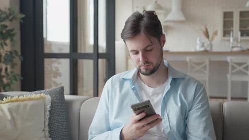 Man Uses Phone and Credit Card at Home