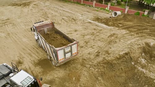Building Foundations Aerial of Excavators and Trucks at Site